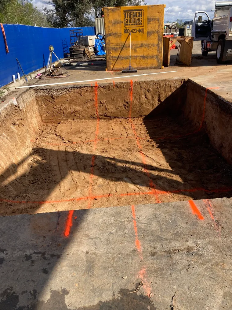 Precisely excavated foundation pit marked out on a commercial job site