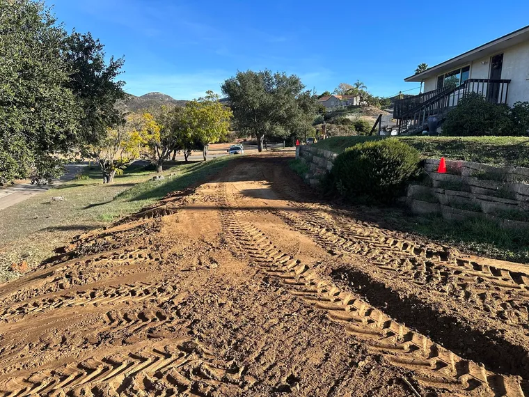 Freshly graded dirt driveway at a residential property
