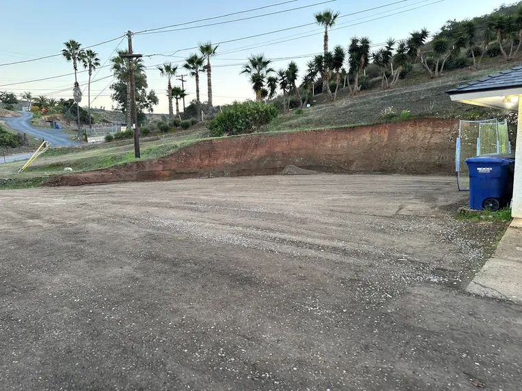 Cut slope and new gravel driveway on a hillside property