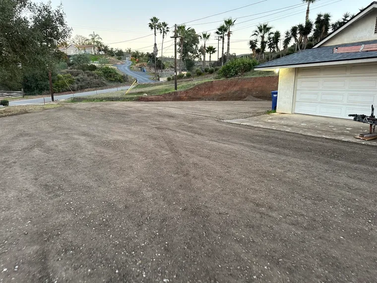Compacted gravel driveway finished at a hillside home